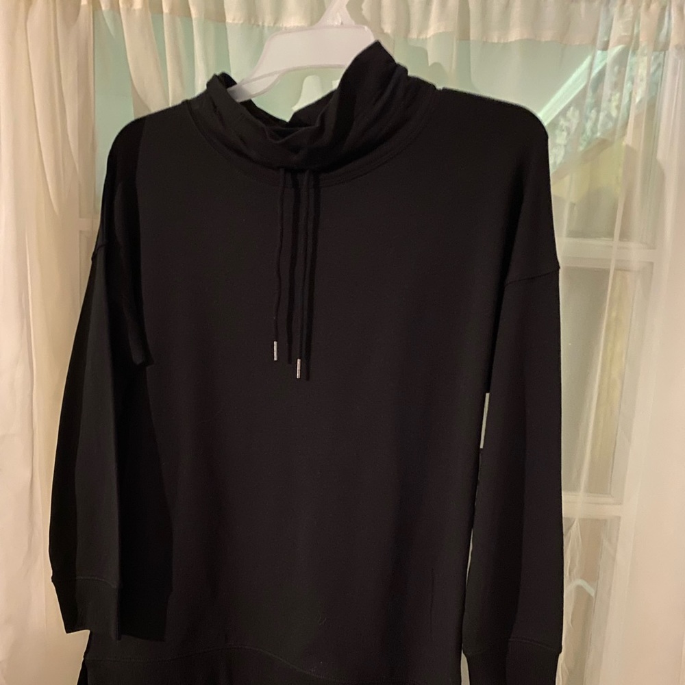 Boys black shirt with pull string around the neck for outstanding style.